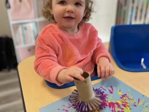 a girl sitting at a table