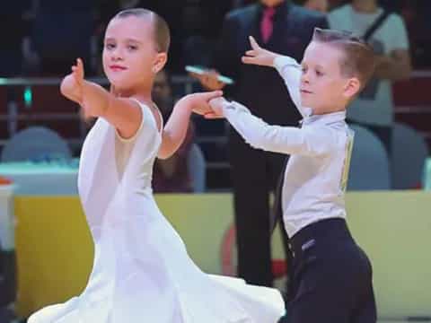 a couple of children dancing