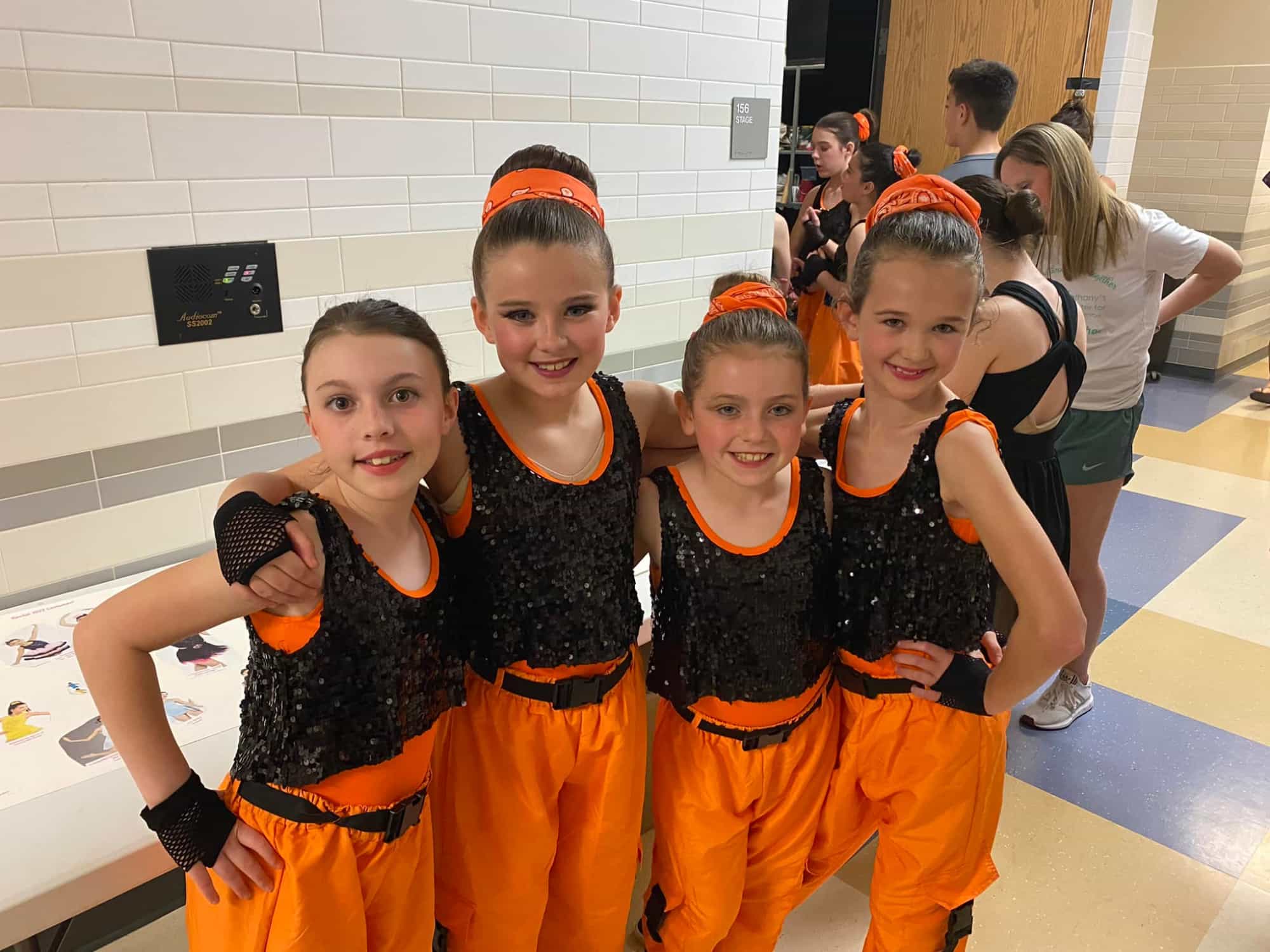 a group of girls in orange jumpsuits