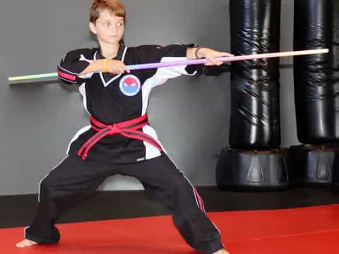 a boy in a martial arts uniform