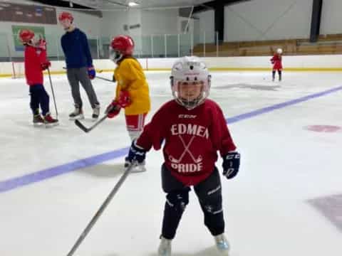 a group of kids playing hockey
