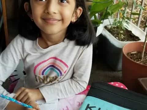 a girl holding a pen