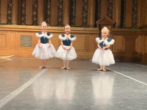 a group of girls in white dresses