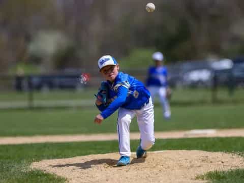 a kid throwing a baseball