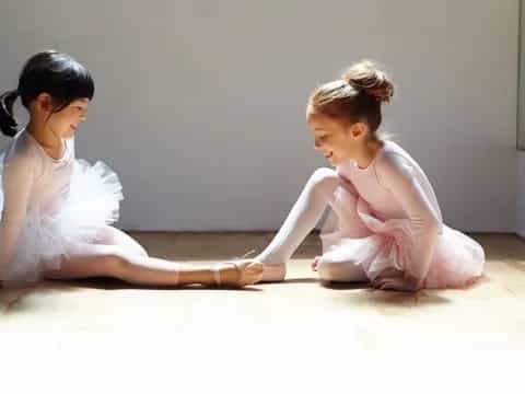two girls sitting on the floor