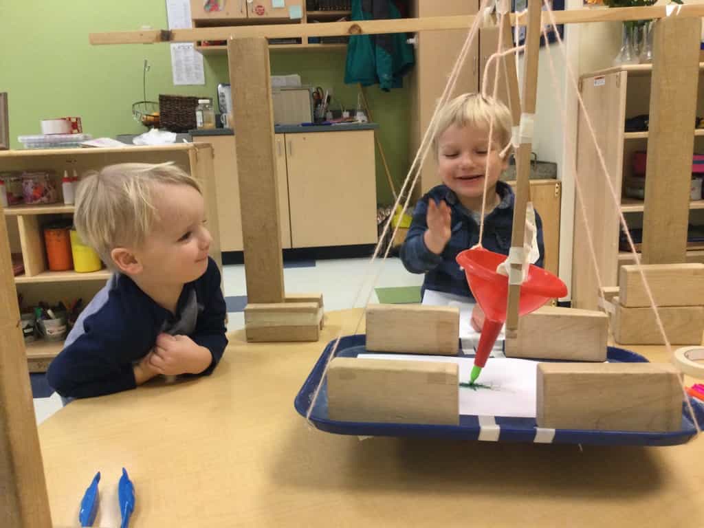a couple of kids playing with building blocks