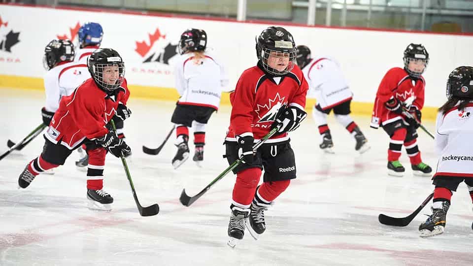a group of people playing hockey