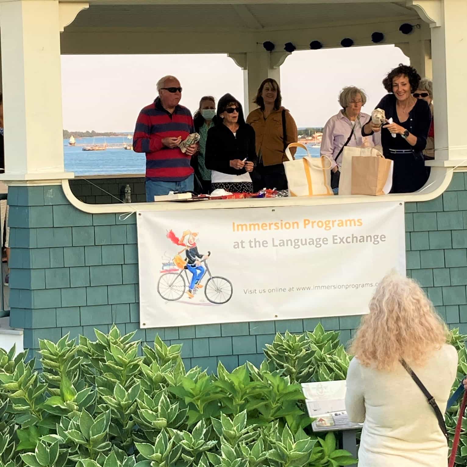 a group of people standing around a sign