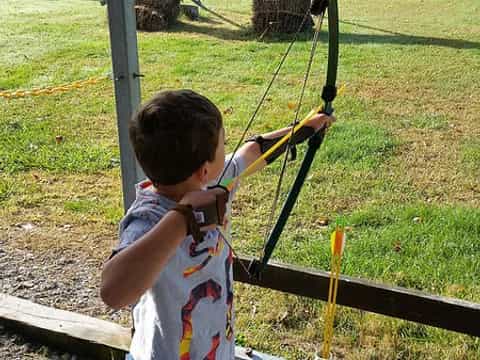 a boy shooting a bow