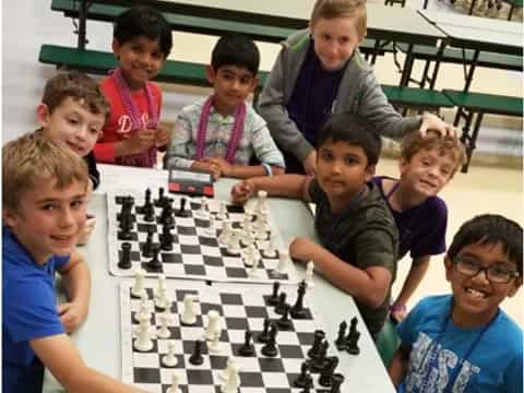 a group of boys playing chess