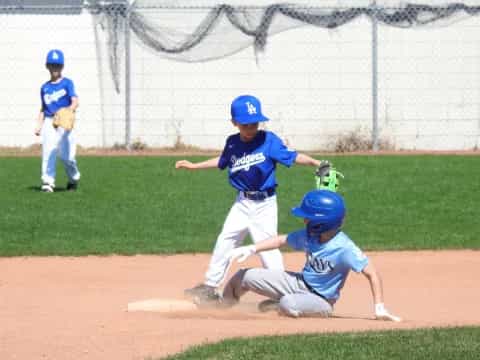 kids playing baseball on a field