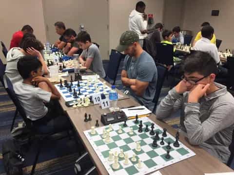 a group of people playing chess