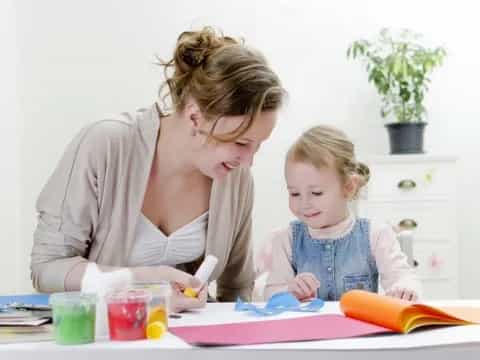 a person and a child painting