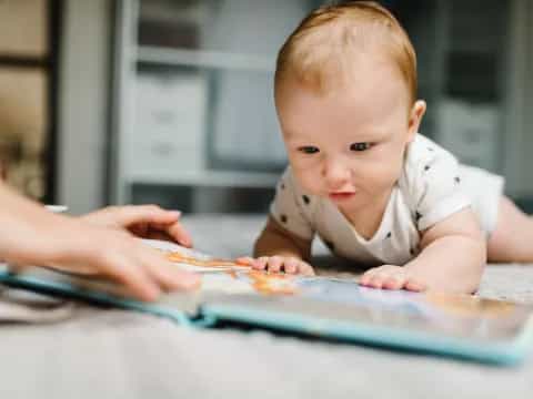 a baby looking at a tablet