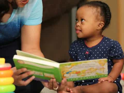 a baby holding a book