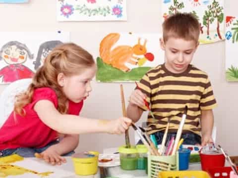 a boy and girl painting