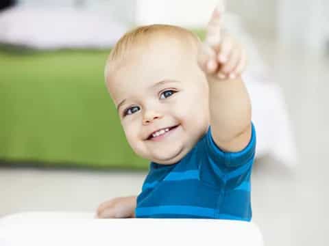 a baby with a thumbs up