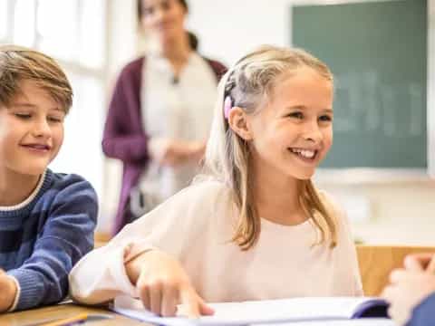 a few children sitting at a table