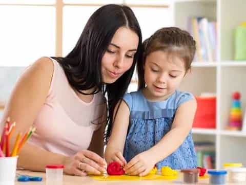 a woman and a child painting