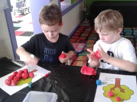 two boys sitting at a table