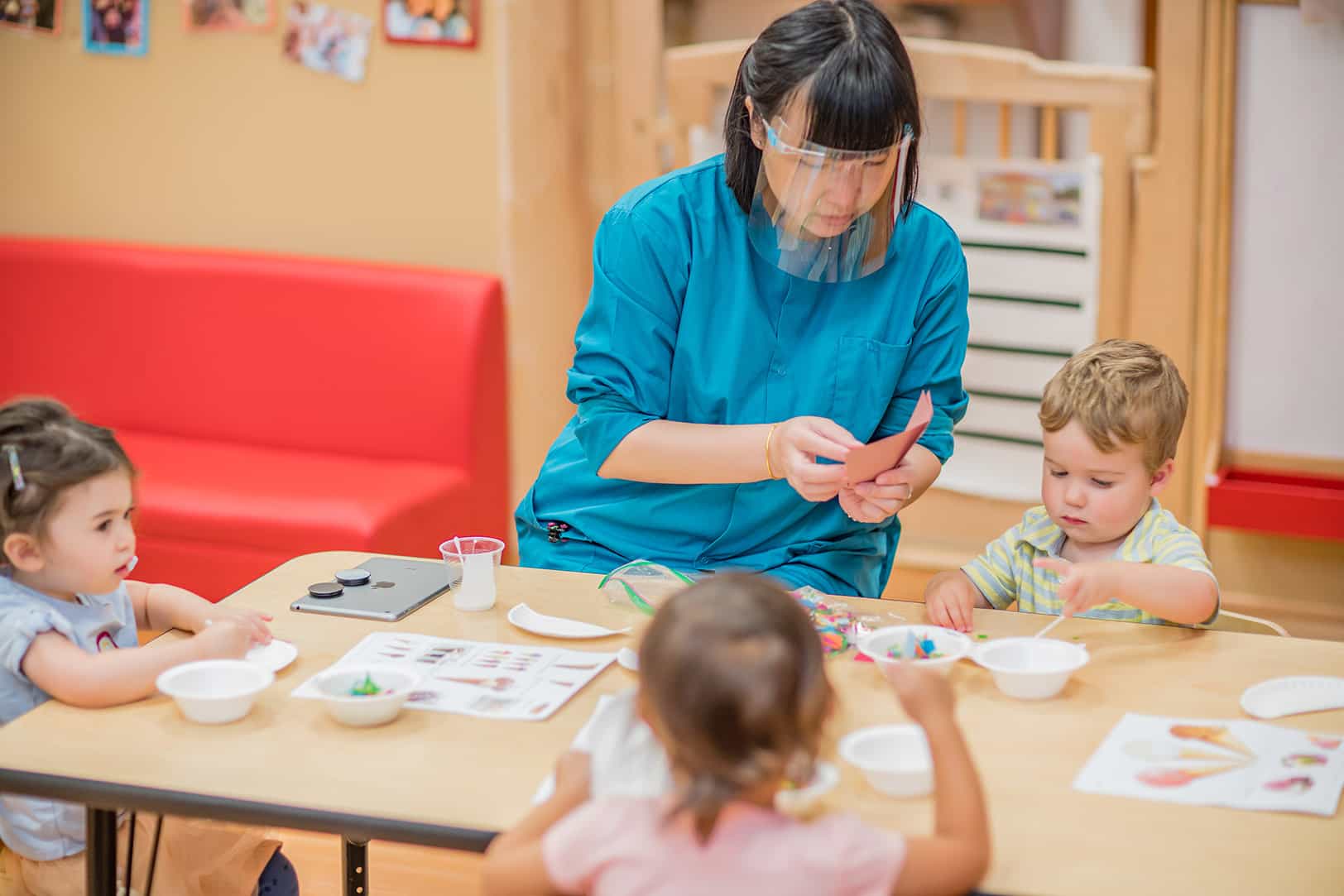 a person and kids sitting at a table
