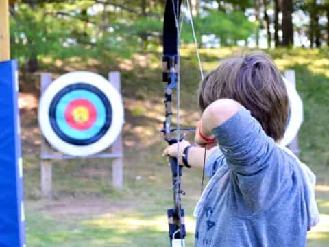 a girl holding a bow and arrow