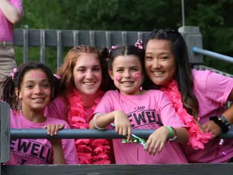 a group of girls in pink shirts