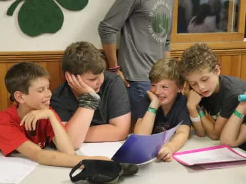 a group of boys sitting at a table