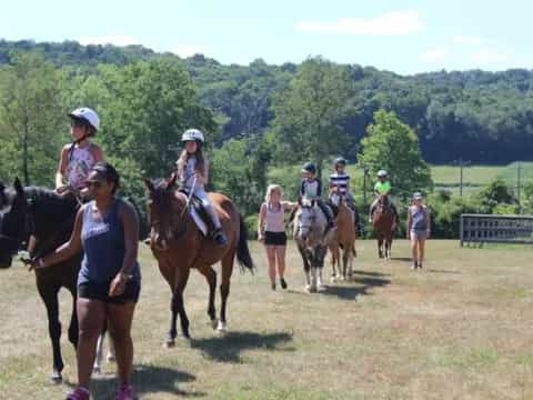 a group of people riding horses