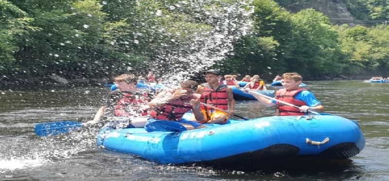 a group of people in a raft on a river