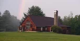 a large barn with a chimney