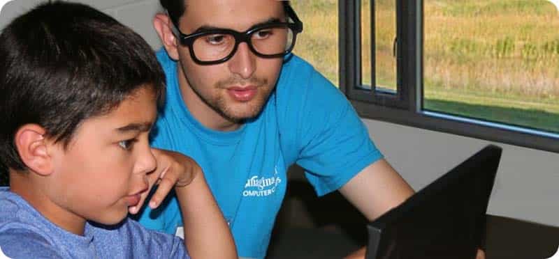 a man and a boy looking at a laptop