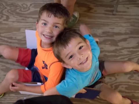 two boys lying on the floor