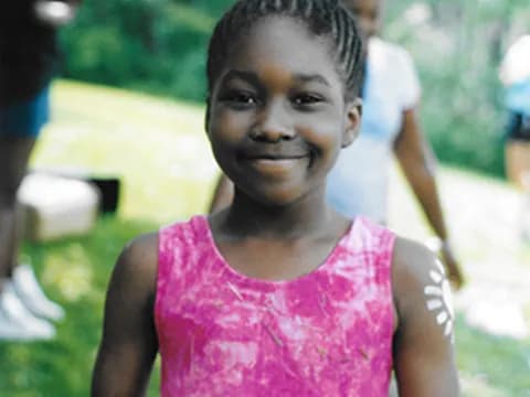 a young girl smiling