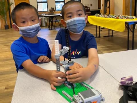 two boys playing with a toy