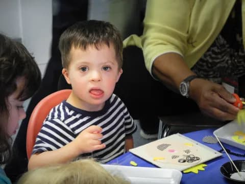 a child sitting at a table