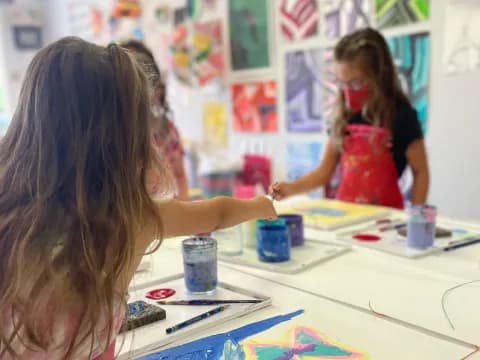 a girl painting on a table