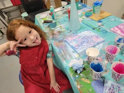 a girl sitting at a table