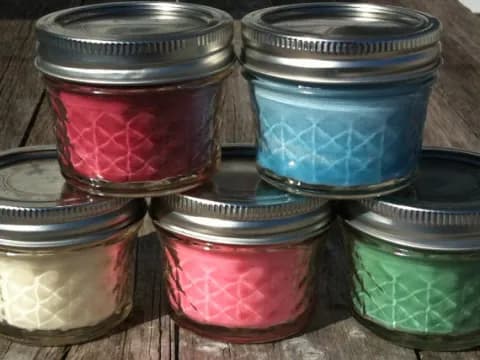 a group of jars with red jam