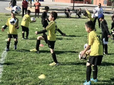 a group of kids playing football