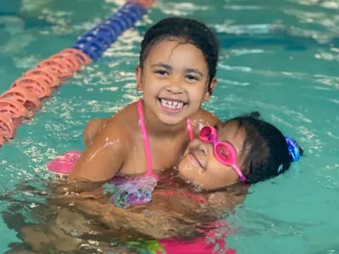 a girl and a baby in a pool