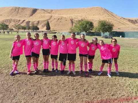 a group of girls in pink shirts