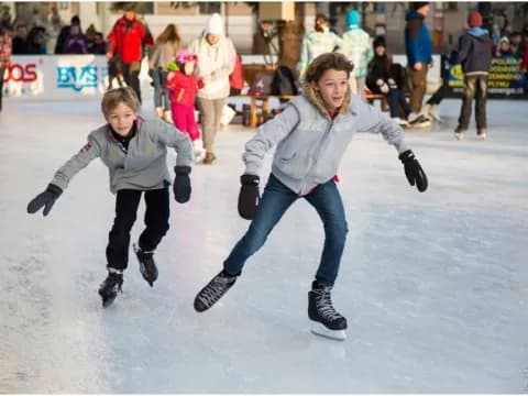 a couple of people ice skating