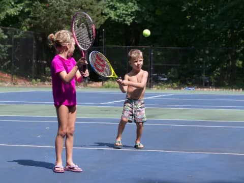 kids playing tennis on court