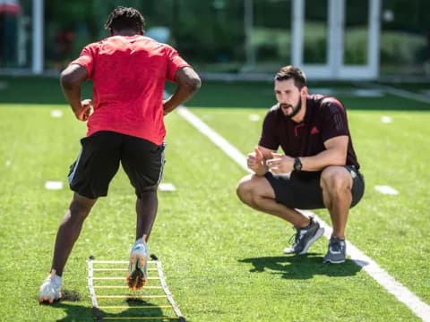 two men running on a grass field