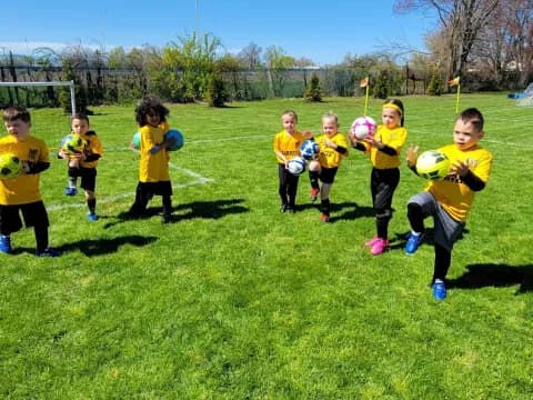 a group of kids playing football