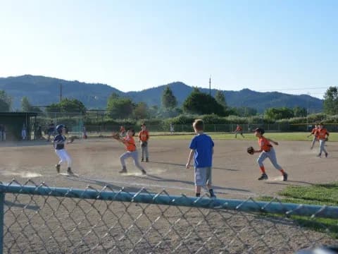 a group of kids playing baseball