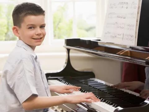 a boy playing a piano