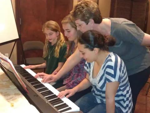 a group of people playing a piano
