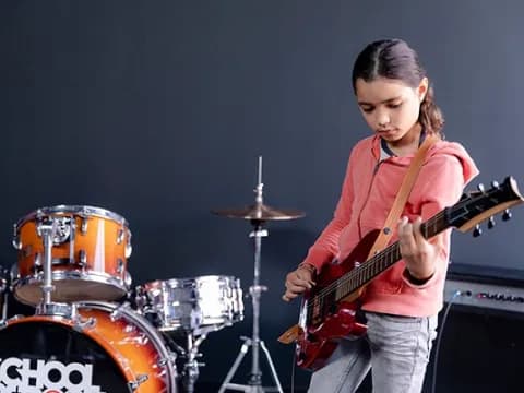 a girl playing a guitar
